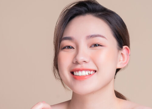 Photo of a smiling young woman after Jeuveau® treatments