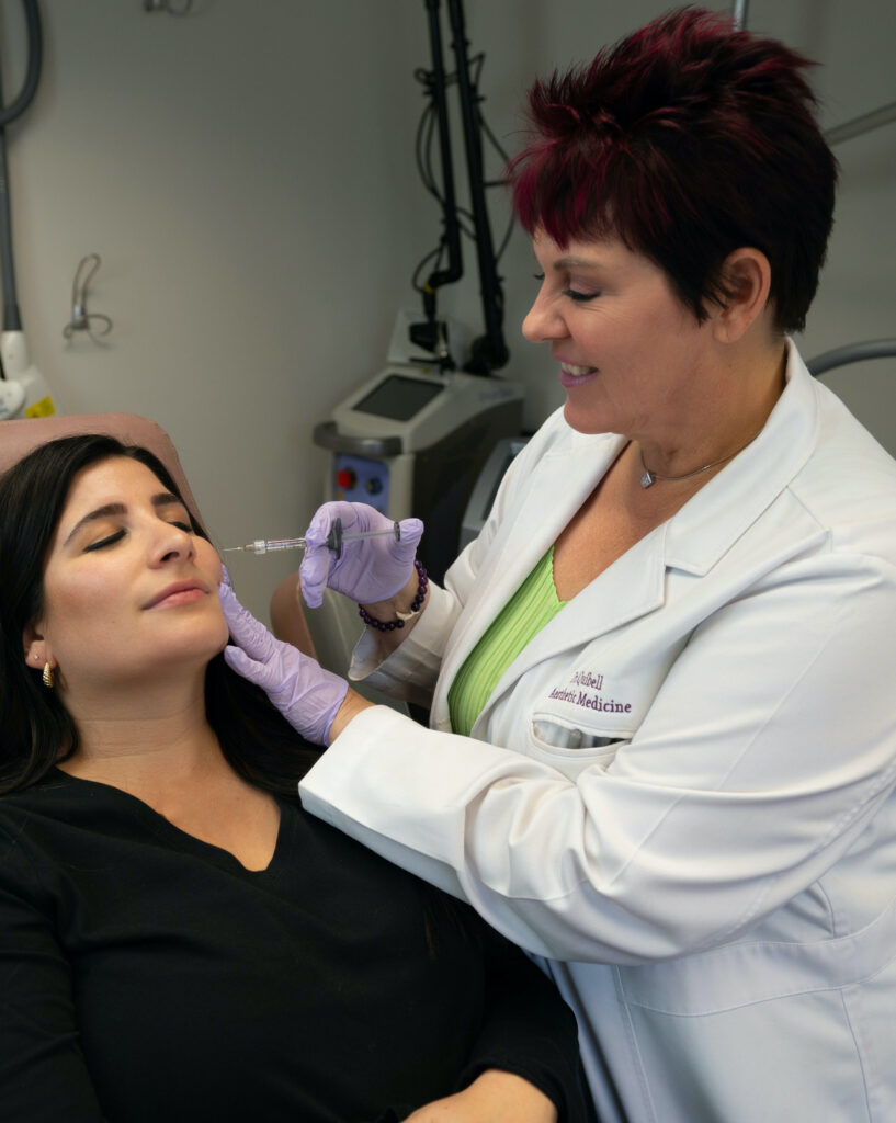 Photo of Dr. Quibell giving Ali a dermal filler treatment