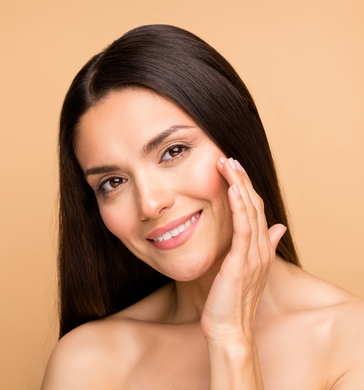 Photo of a brunette woman with glowing skin
