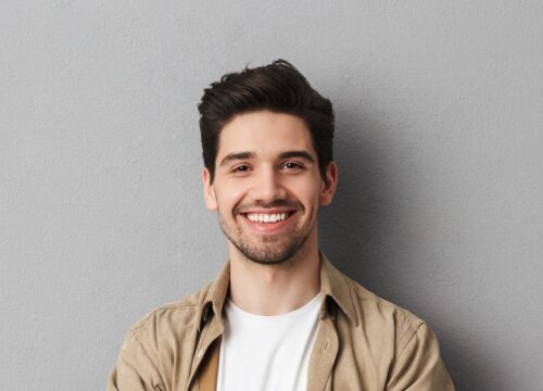 Photo of a happy man with a full head of hair after hair restoration treatments
